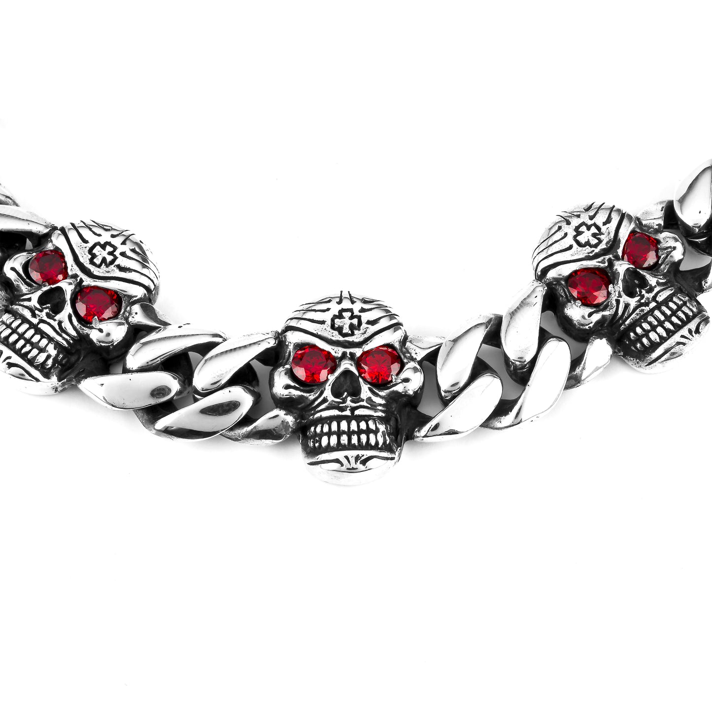 A close-up of a handmade 925 silver chain bracelet with Mexican engraved silver skulls and natural garnet stone eyes. 